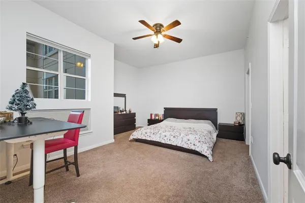 a bedroom with a bed and a table in it