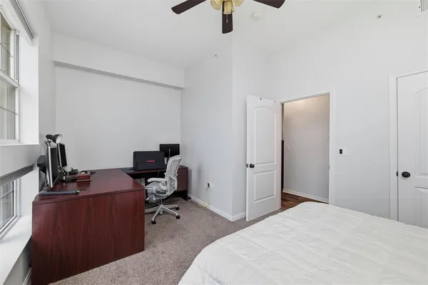a bedroom with a workspace