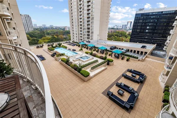 a view of a city from a balcony with chairs