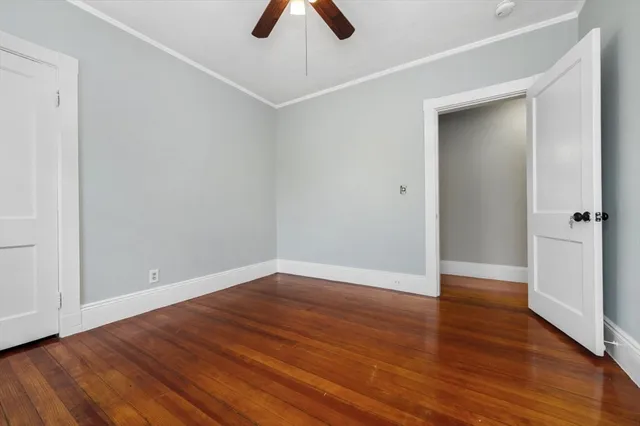 an empty room with wooden floor and closet