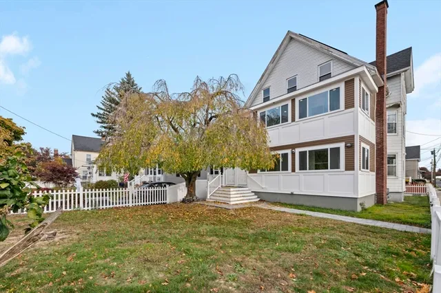 a front view of a house with a garden and plants