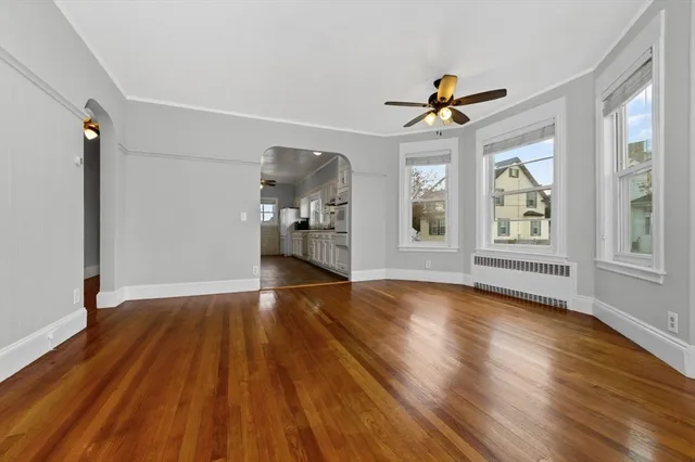 wooden floor in an empty room with a window