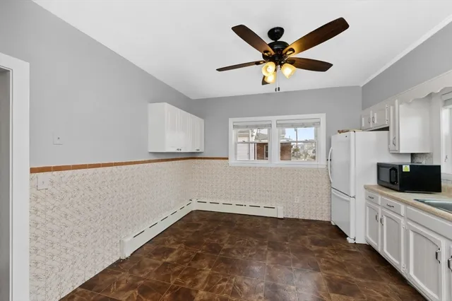 a view of a kitchen with a sink and a ceiling fan
