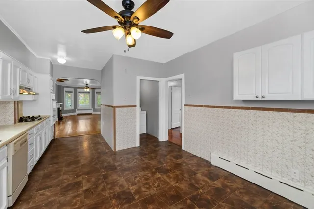 a view of a kitchen with a sink and a refrigerator