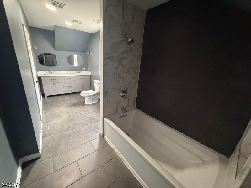 166 Renner Avenue, Unit 3 Newark, NJ 07112 - Photo 15 of 24 a spacious bathroom with a bathtub sink and toilet