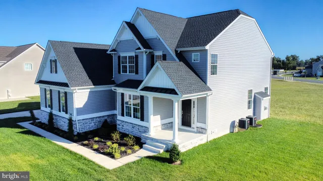 a front view of house with a garden and deck