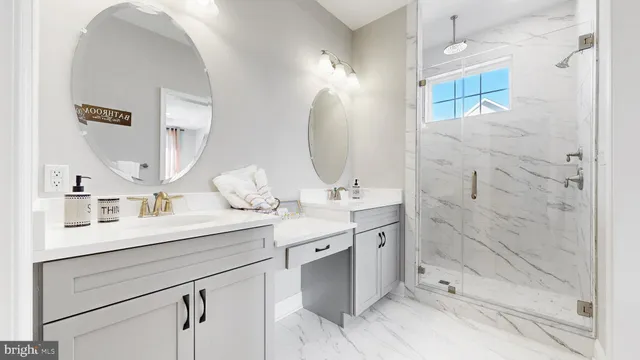 a bathroom with a double vanity sink mirror and shower