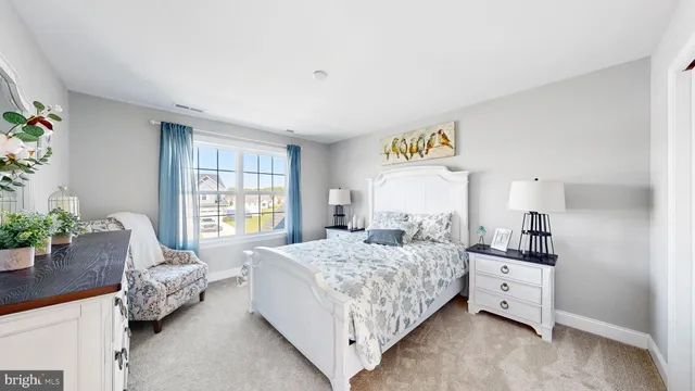 a bedroom with a bed and a potted plant