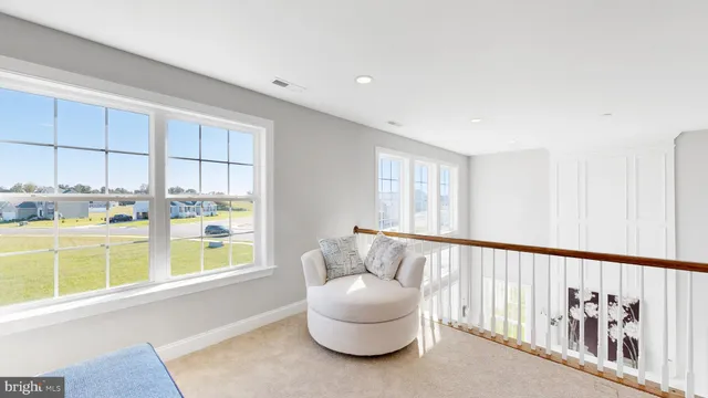 a bedroom with furniture and a large window