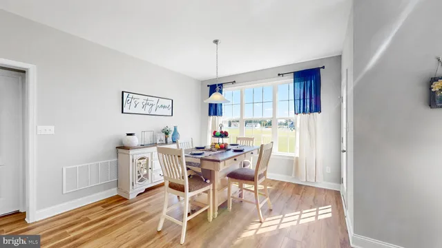 a view of a dining room with furniture and a rug