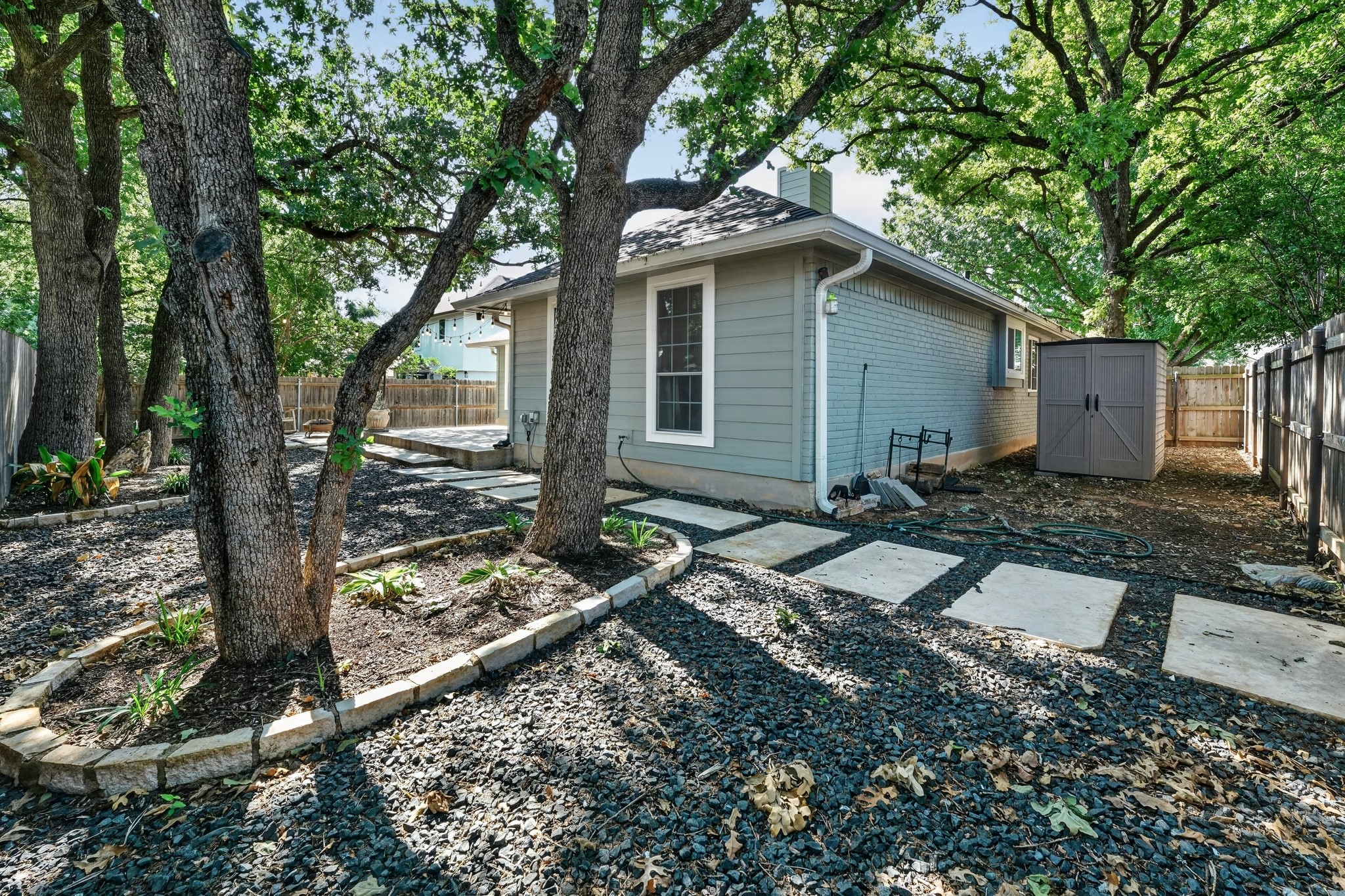 1811 Old Mill Road Cedar Park, TX 78613 - Photo 36 of 39 Mature trees shade a private yard with a large patio and charming storage shed.