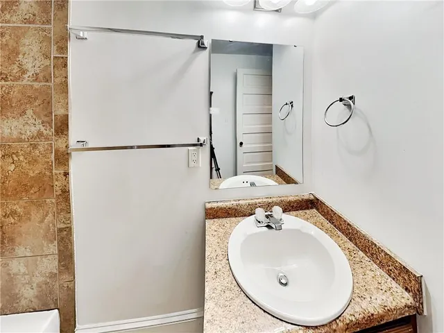 a bathroom with a sink and a mirror