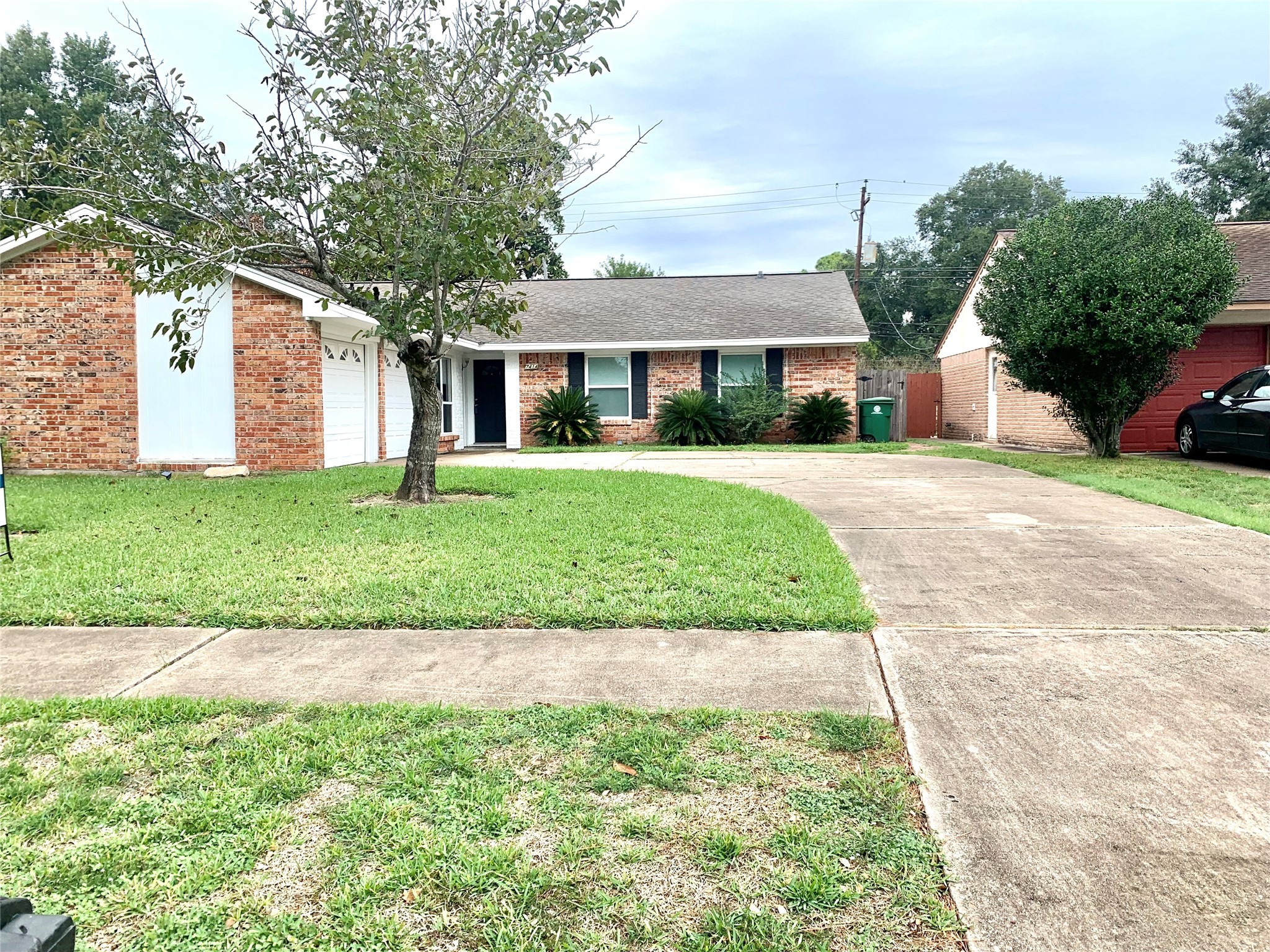 7414 Carew Street Houston, TX 77074 - Photo 1 of 15 a front view of a house with a garden and trees