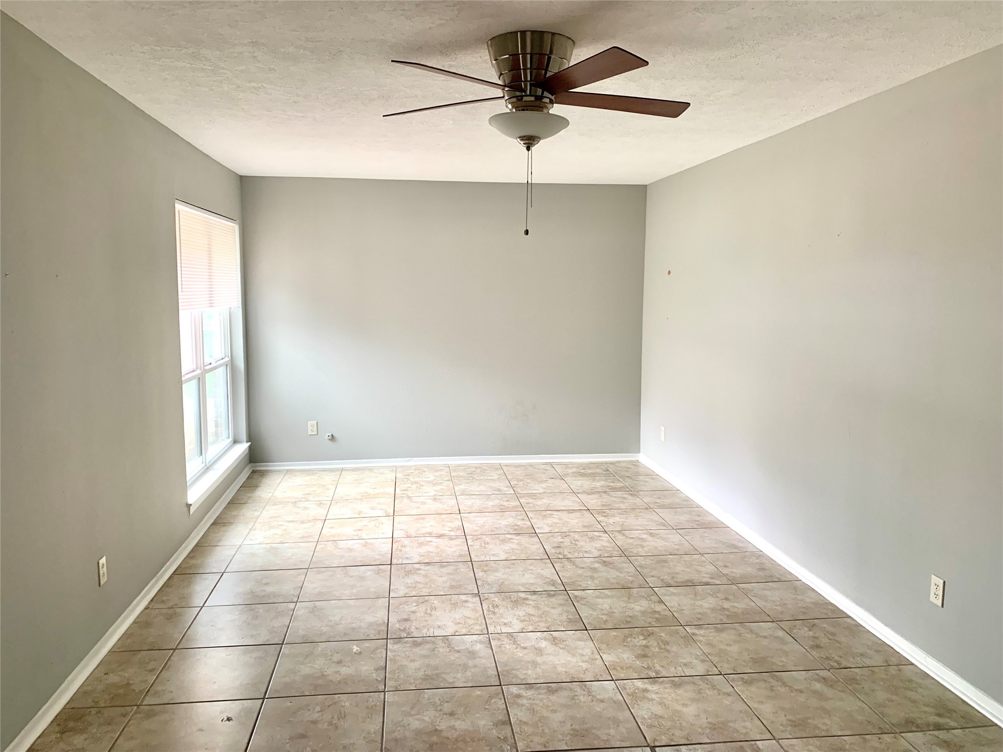 7414 Carew Street Houston, TX 77074 - Photo 12 of 15 a view of an empty room and window with a chandelier fan