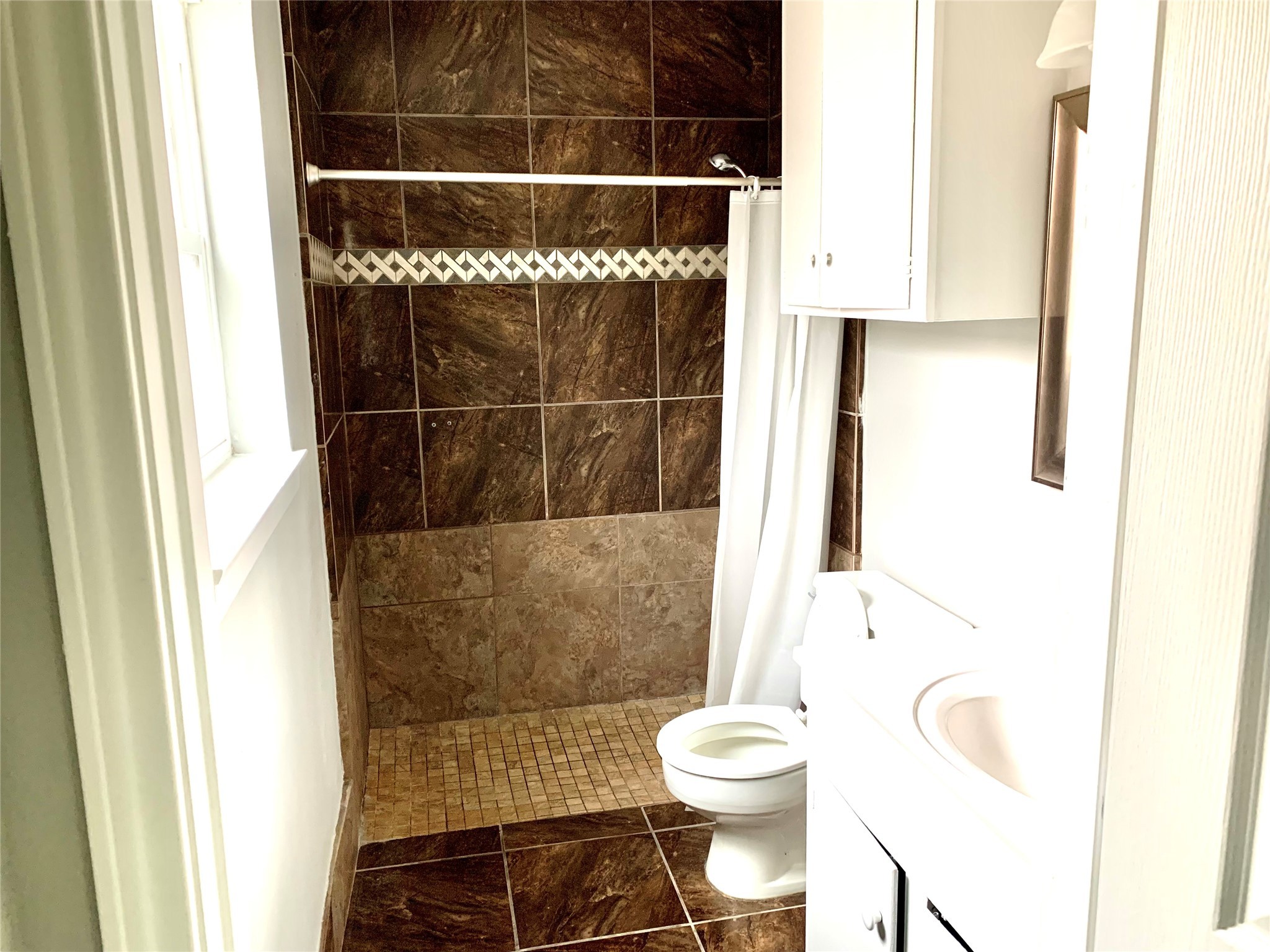 7414 Carew Street Houston, TX 77074 - Photo 13 of 15 a bathroom with a toilet and a shower