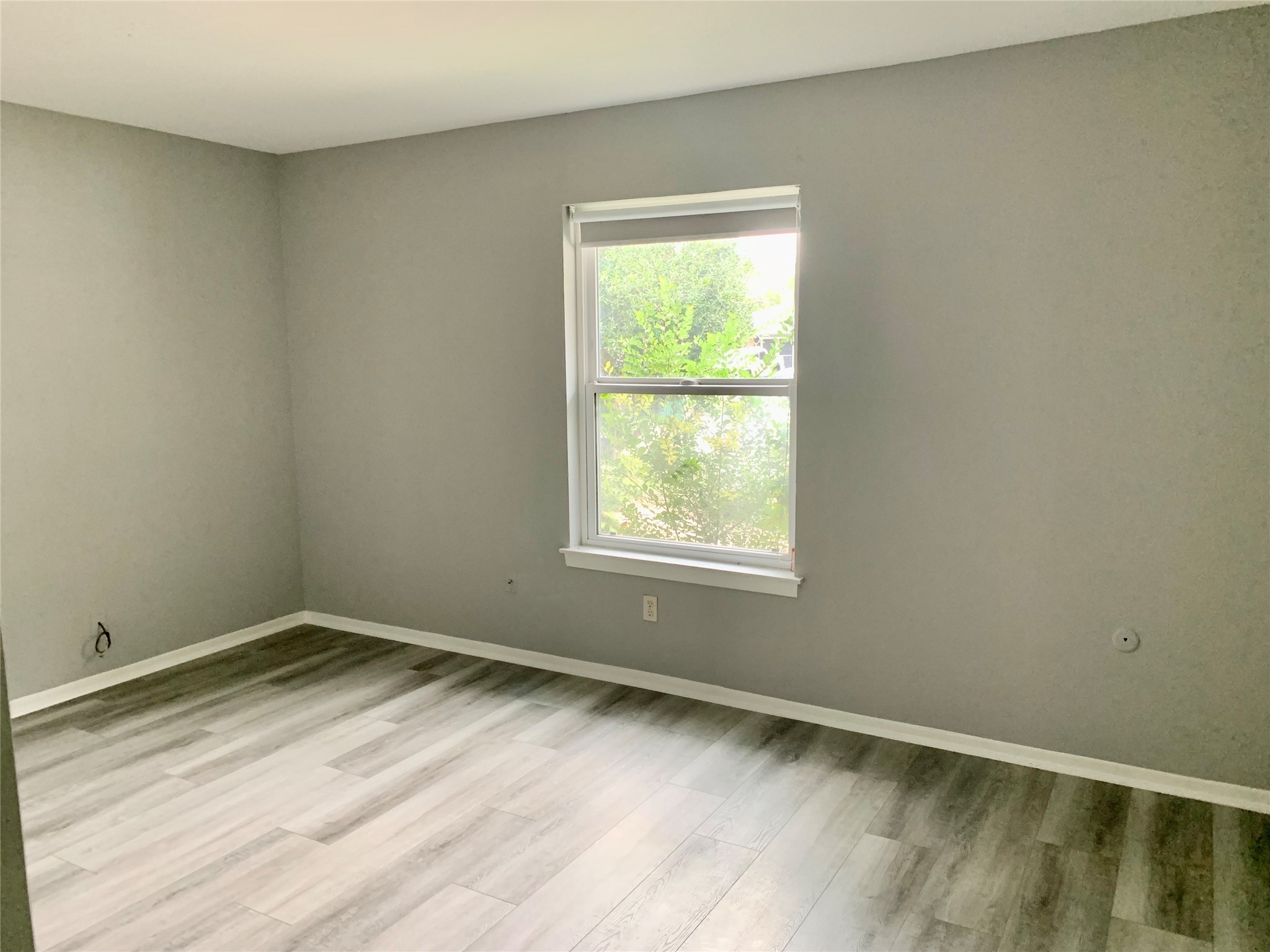 7414 Carew Street Houston, TX 77074 - Photo 14 of 15 a view of an empty room with wooden floor and a window