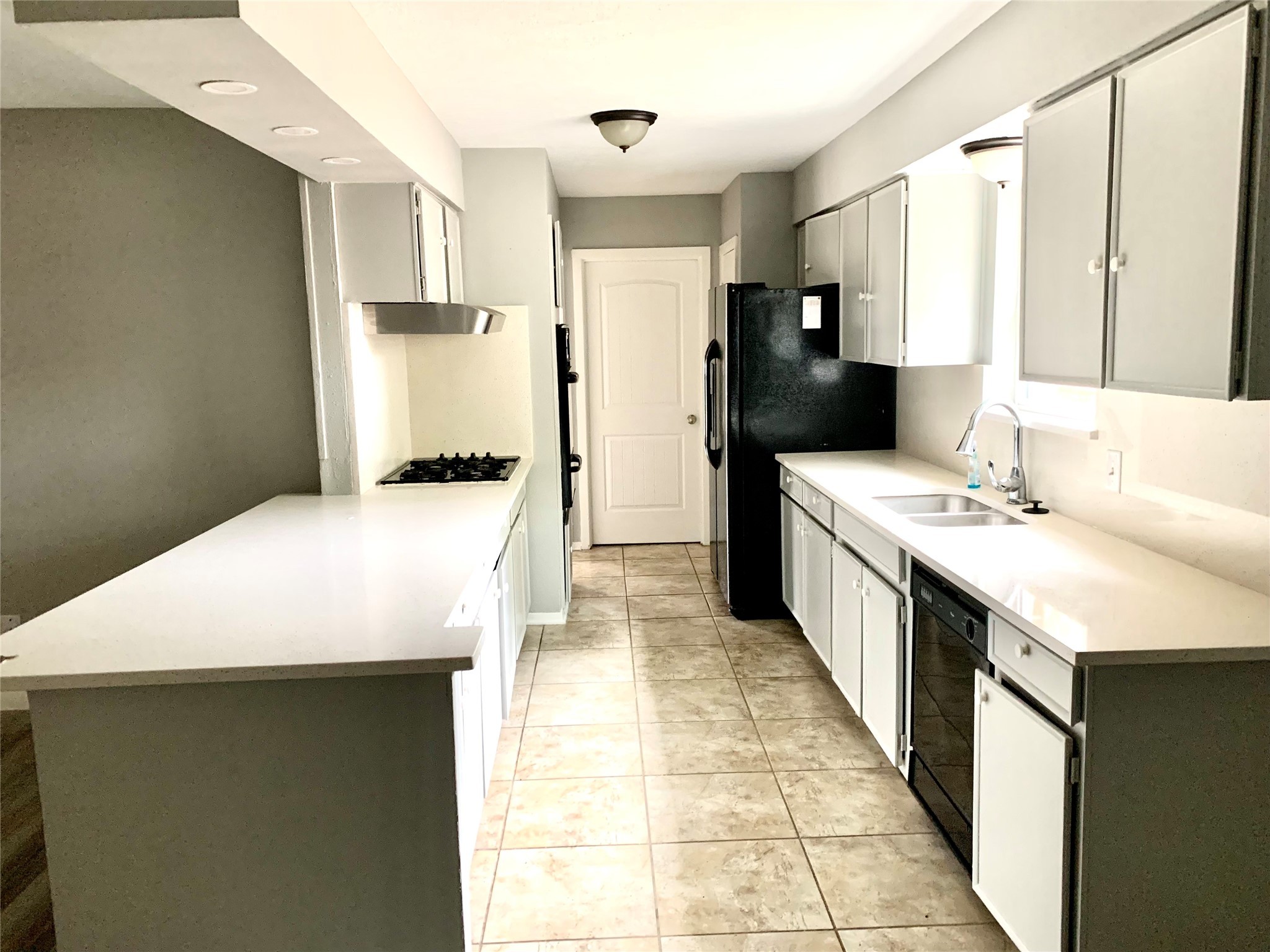 7414 Carew Street Houston, TX 77074 - Photo 7 of 15 a kitchen with a sink a stove top oven a refrigerator and a window