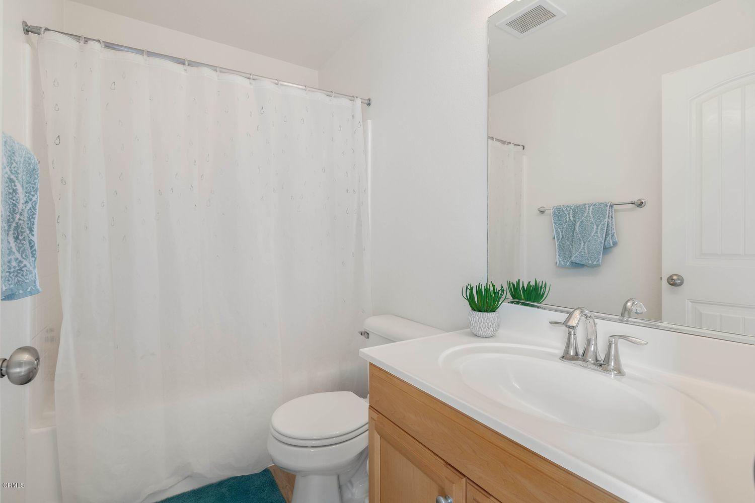 608 Flathead River Street Oxnard, CA 93036 - Photo 16 of 21 a bathroom with a granite countertop sink and a mirror