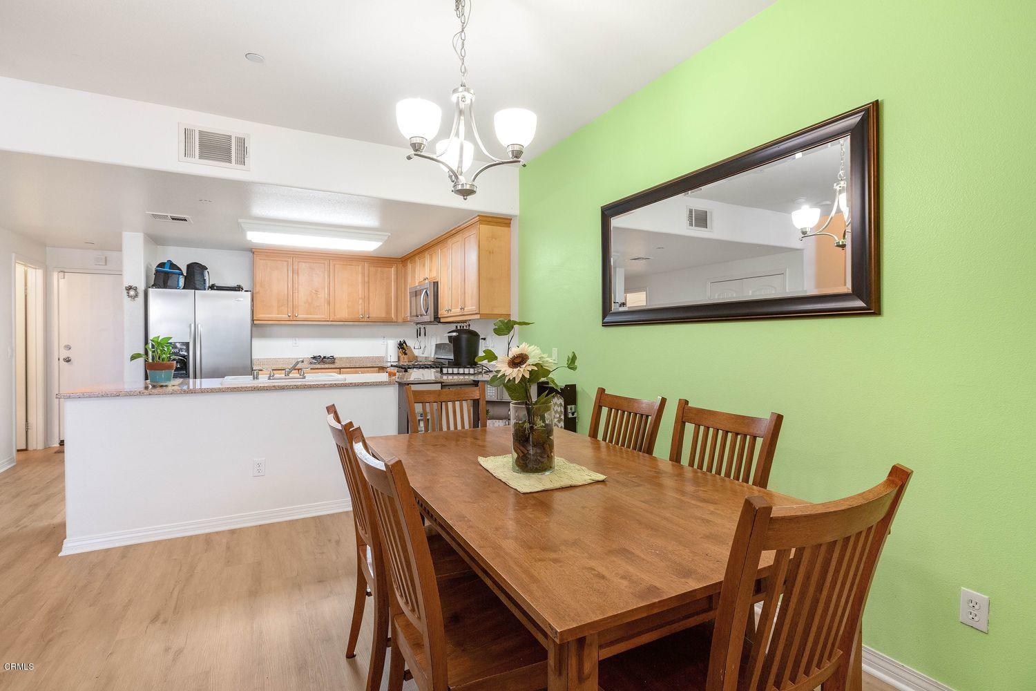 608 Flathead River Street Oxnard, CA 93036 - Photo 6 of 21 a view of a dining room with furniture wooden floor and a chandelier