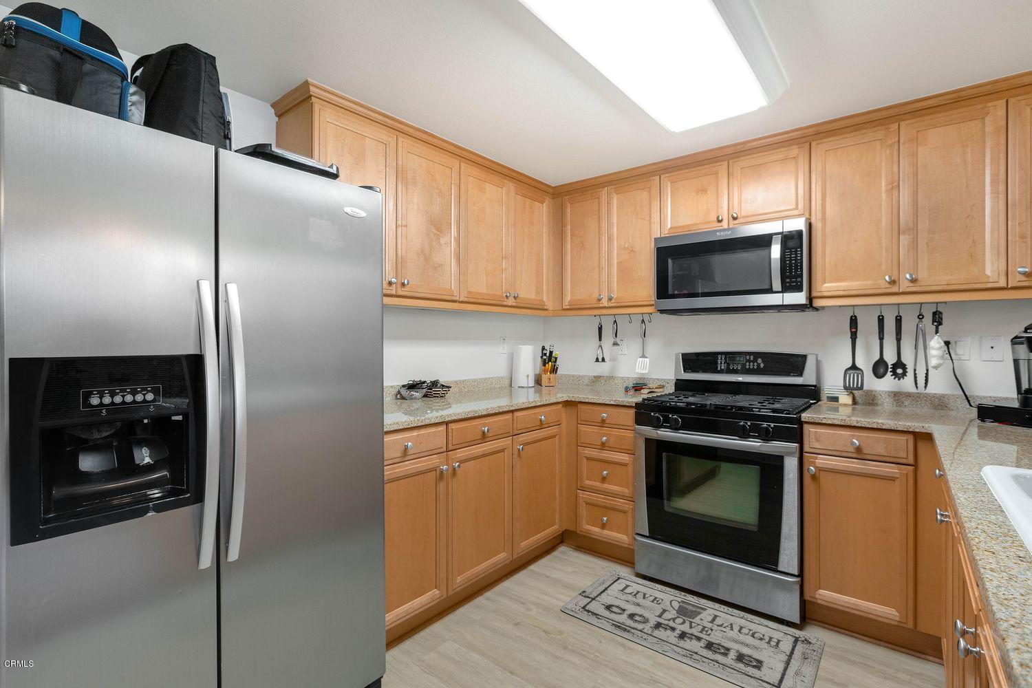 608 Flathead River Street Oxnard, CA 93036 - Photo 9 of 21 a kitchen with stainless steel appliances granite countertop a stove a sink and a refrigerator
