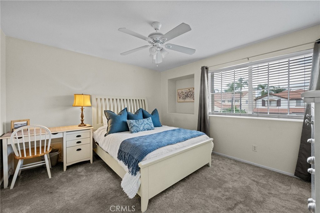 7220 Cumberland Place Rancho Cucamonga, CA 91739 - Photo 28 of 41 Northeast bedroom featuring a ceiling fan and bright, welcoming natural light with plush carpet. Bedroom has a walk-in closet.