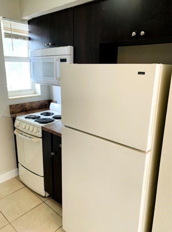 1255 Southwest 6th Street, Unit 4 Miami, FL 33135 - Photo 2 of 9 a kitchen with a refrigerator and a stove