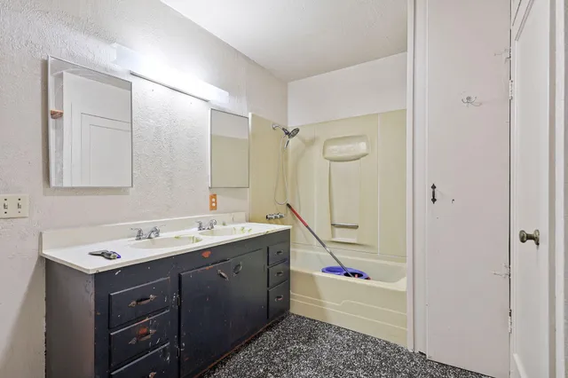 a white toilet sitting next to a shower