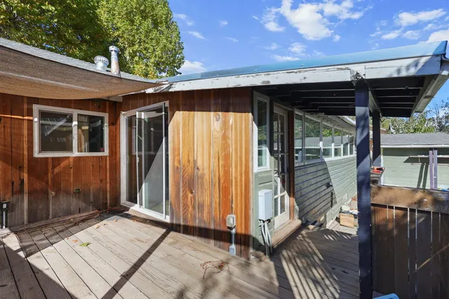 a front view of a house with a yard covered in snow