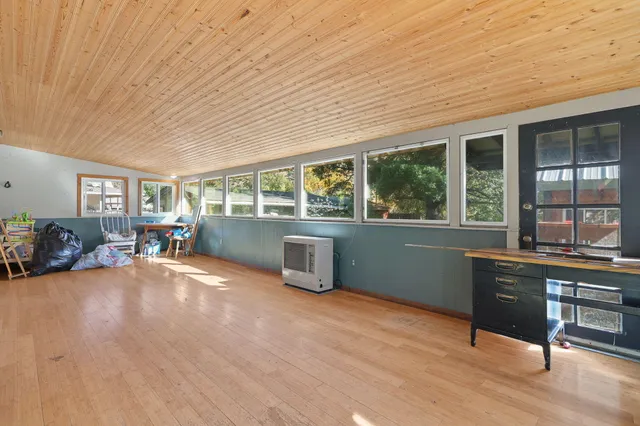 a very nice looking room with wooden floor and walls