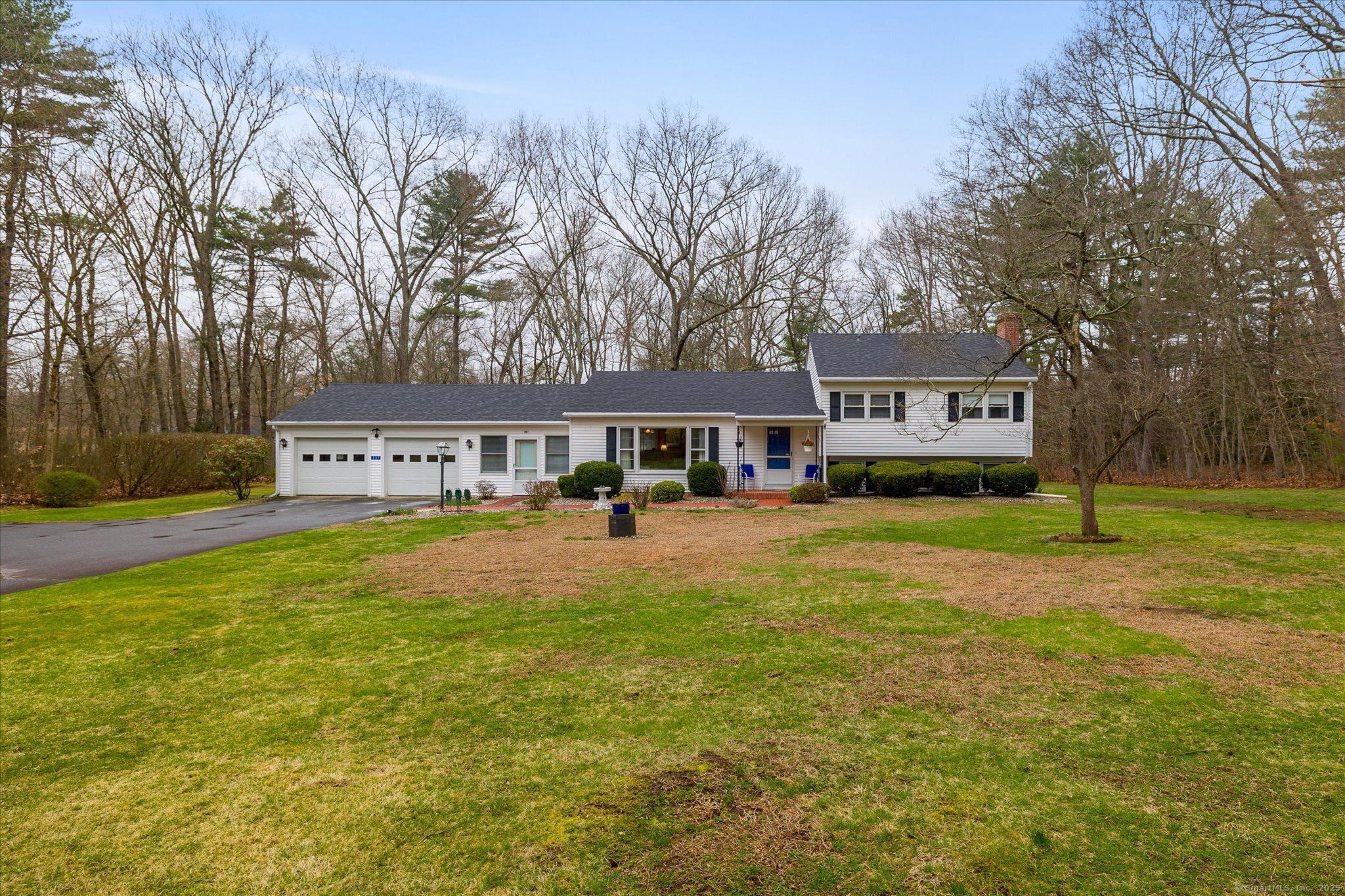 a front view of a house with a yard and trees