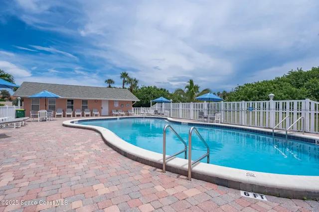 a view of a swimming pool with a patio