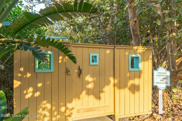 a side view of a house with a tree