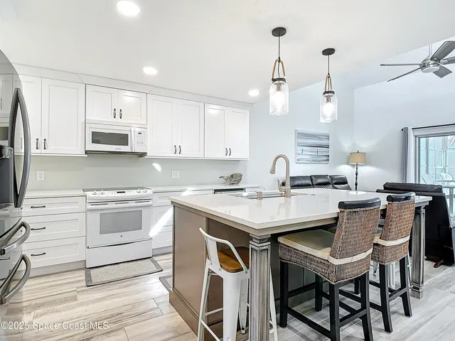 a kitchen with a stove a sink and a refrigerator