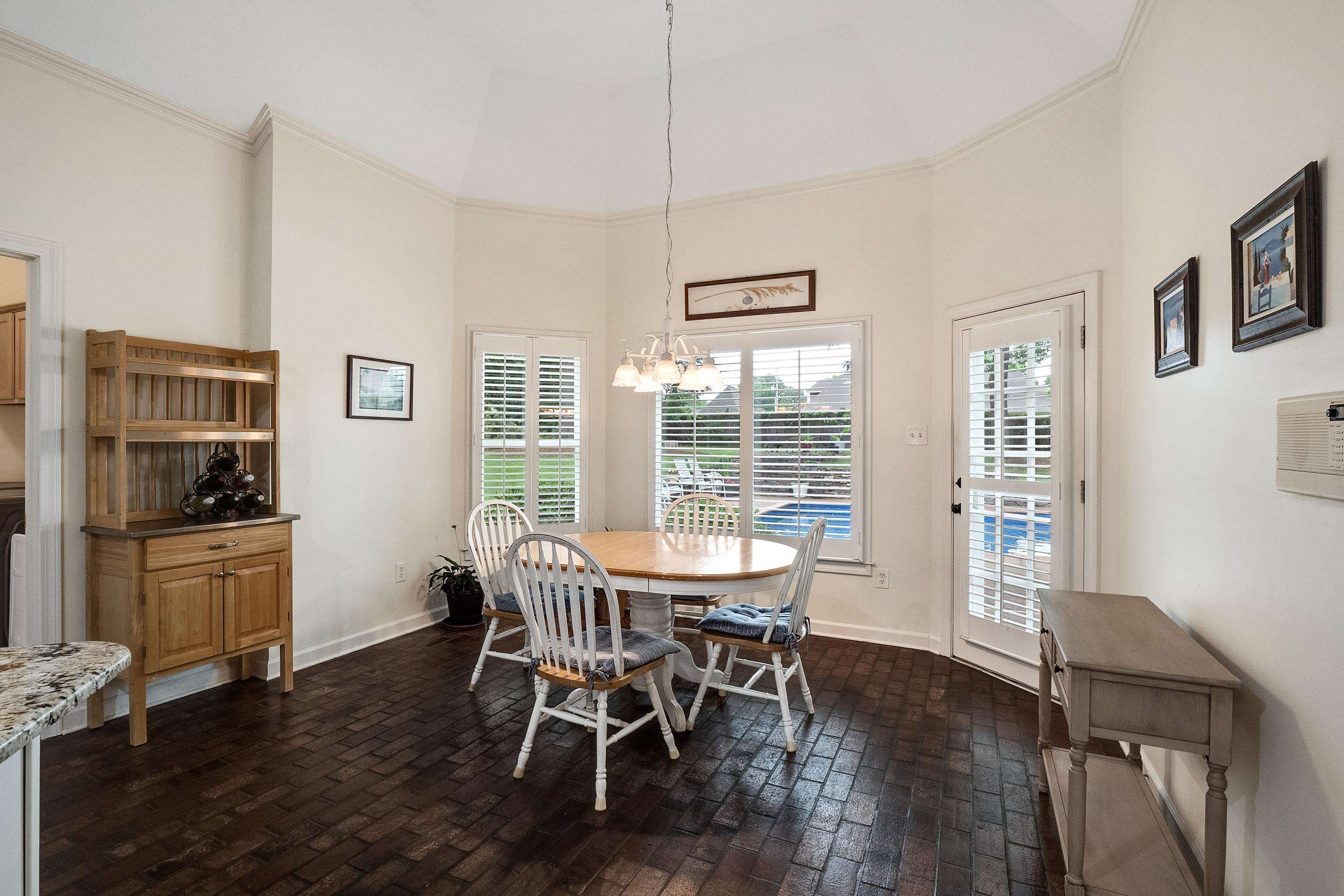 1050 Crosswinds Cove Collierville, TN 38017 - Photo 16 of 40 a view of a dining room with furniture window and wooden floor
