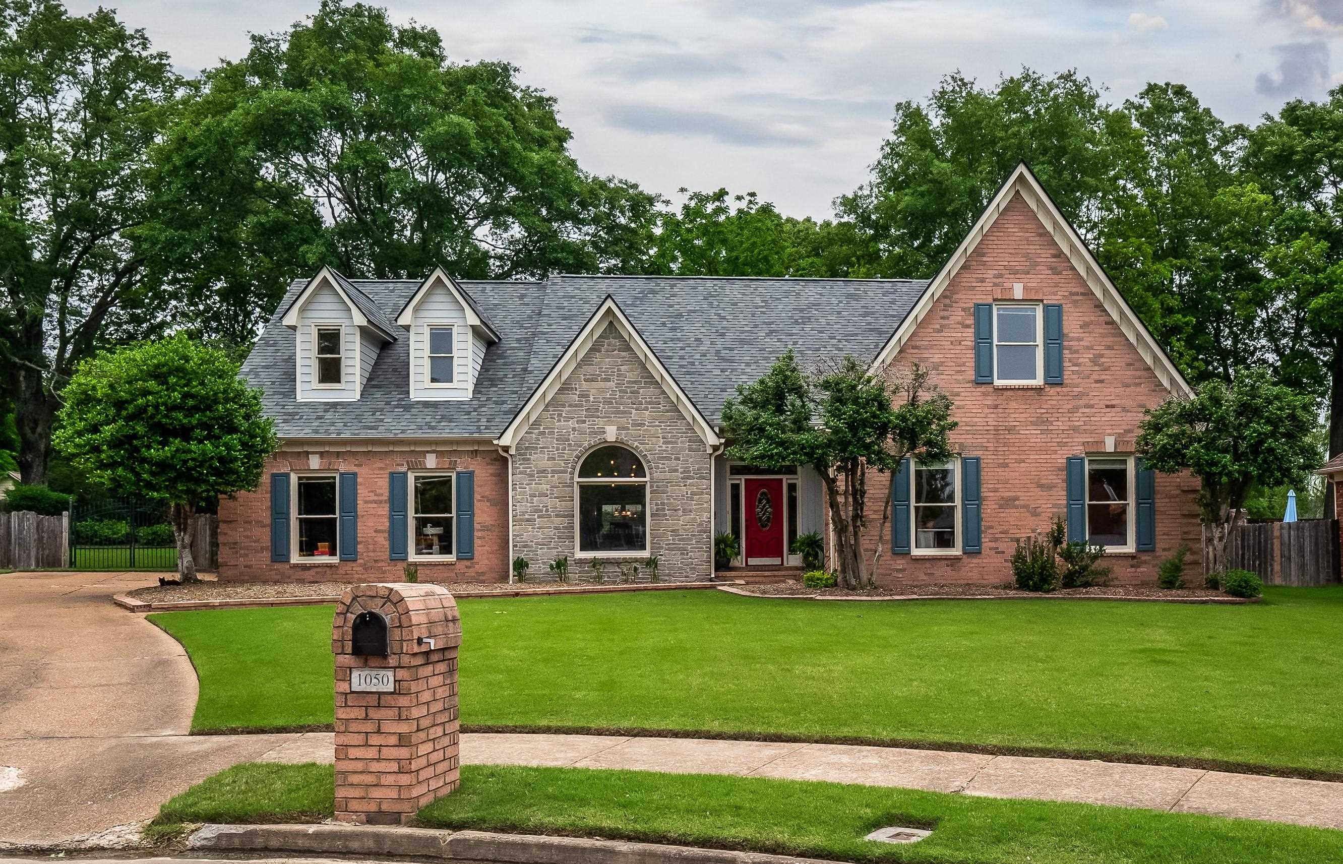 1050 Crosswinds Cove Collierville, TN 38017 - Photo 2 of 40 a front view of a house with a garden and yard