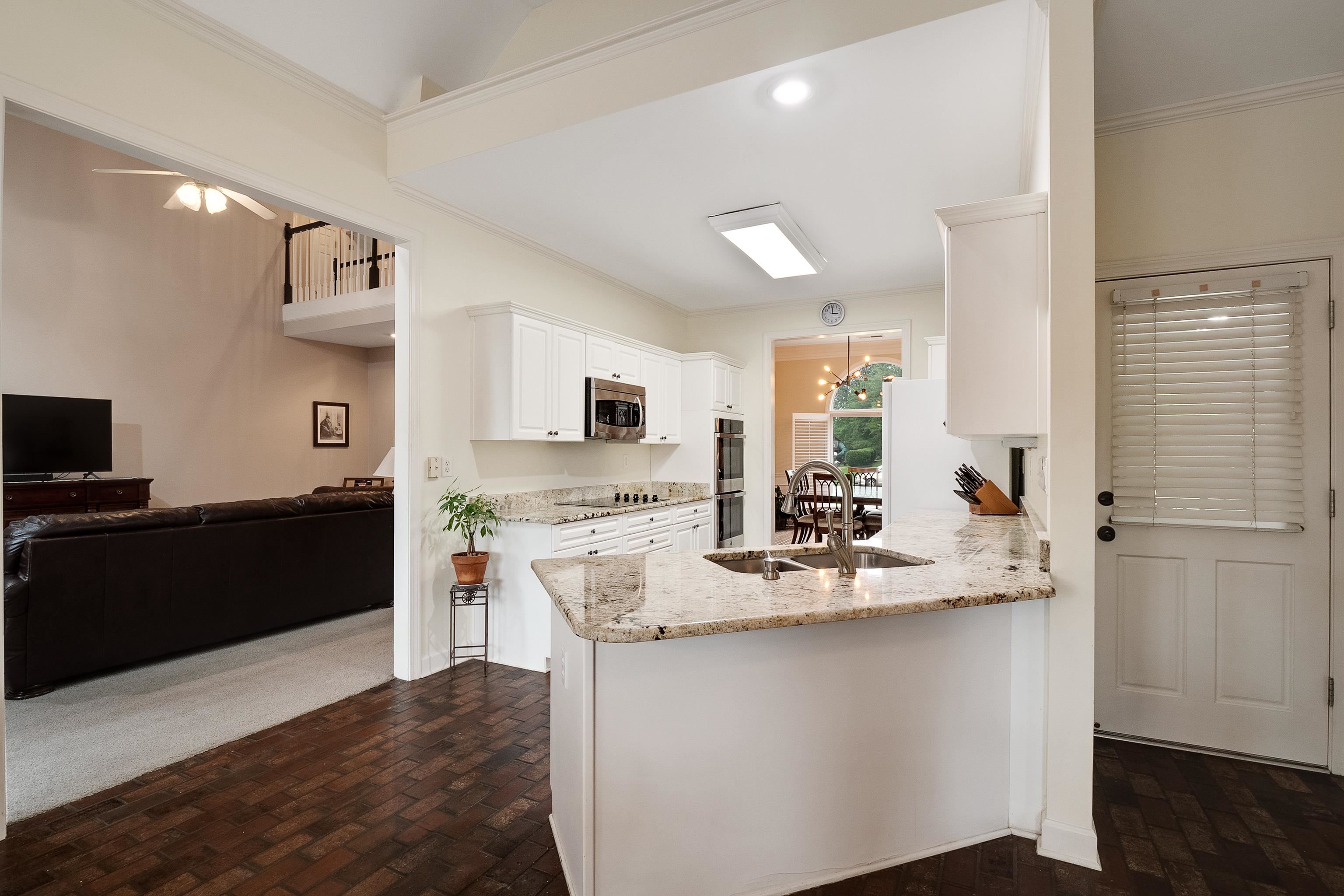 1050 Crosswinds Cove Collierville, TN 38017 - Photo 27 of 40 a kitchen with stainless steel appliances granite countertop a refrigerator and a stove top oven