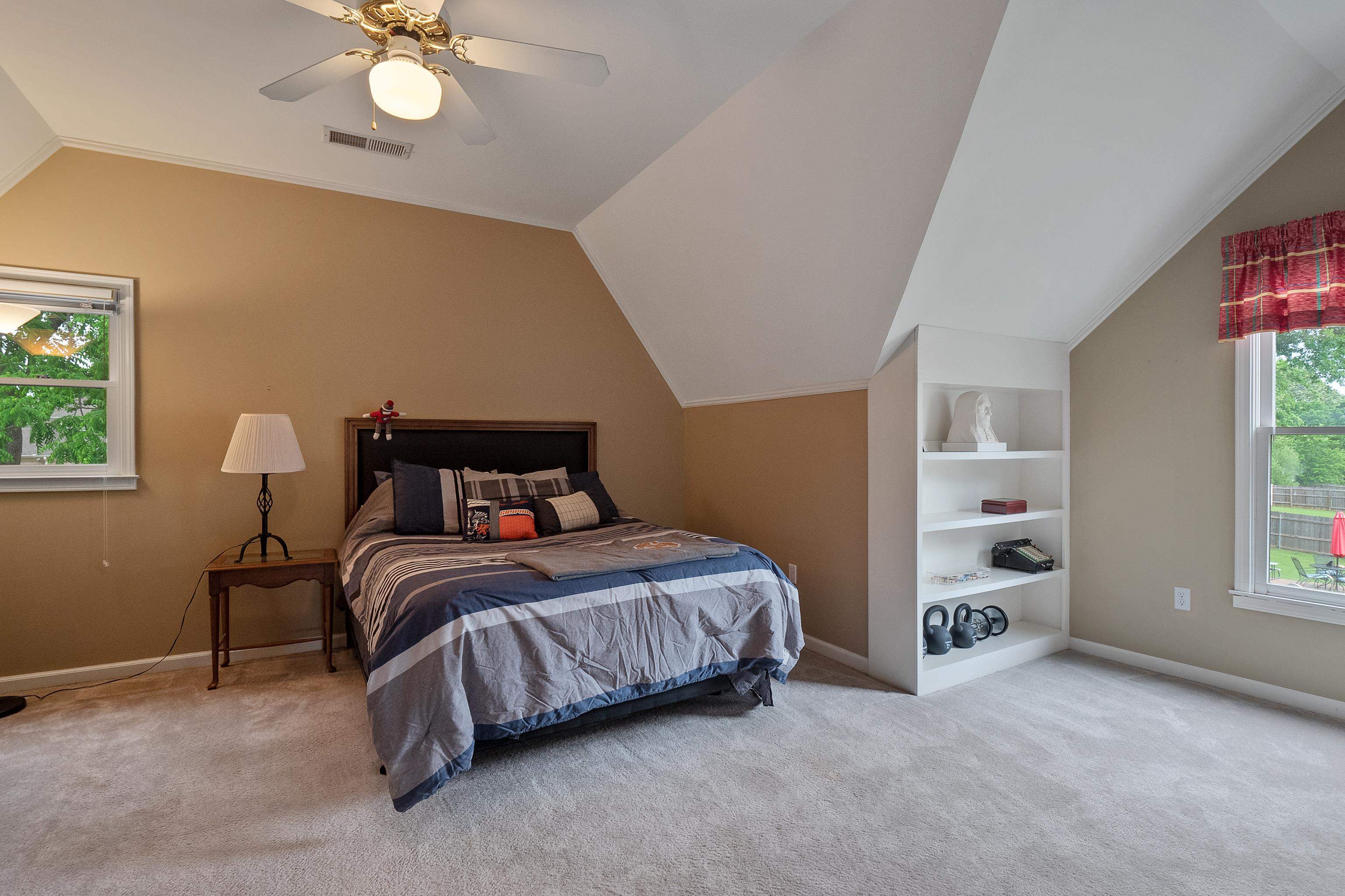 1050 Crosswinds Cove Collierville, TN 38017 - Photo 29 of 40 a bedroom with a bed and a chandelier