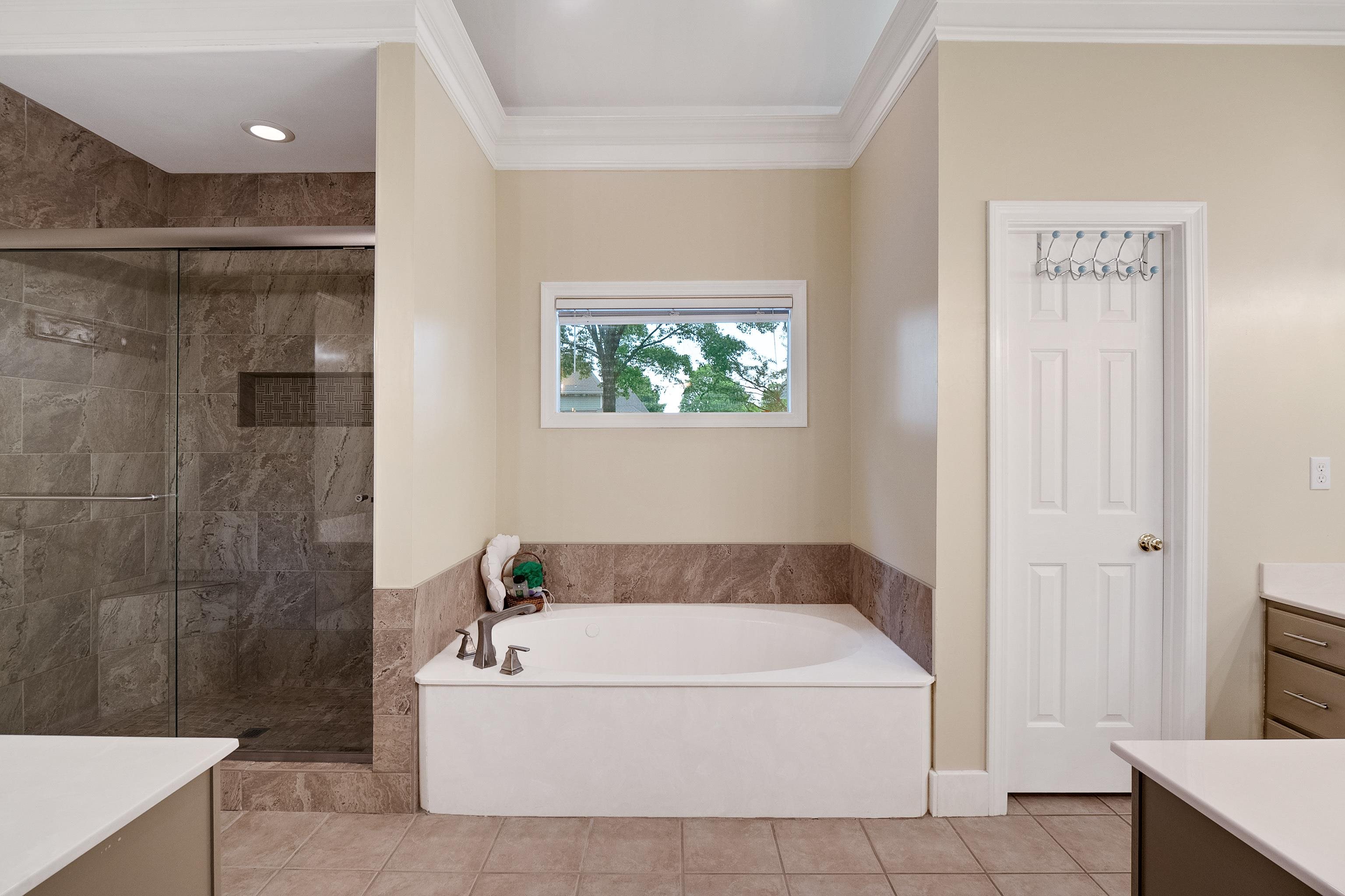 1050 Crosswinds Cove Collierville, TN 38017 - Photo 32 of 40 a white bath tub sitting next to a shower