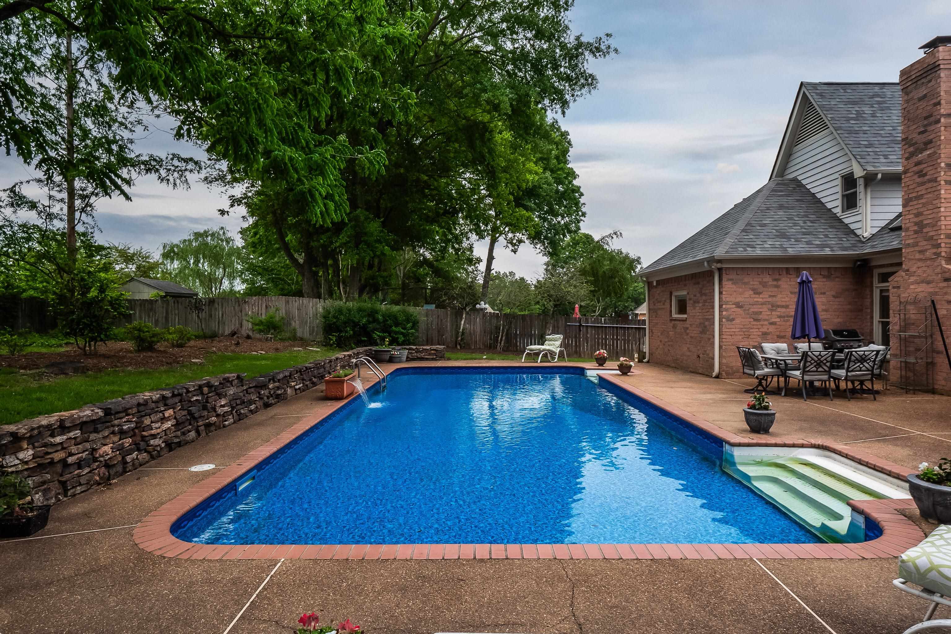 1050 Crosswinds Cove Collierville, TN 38017 - Photo 5 of 40 a view of swimming pool with lawn chairs and plants
