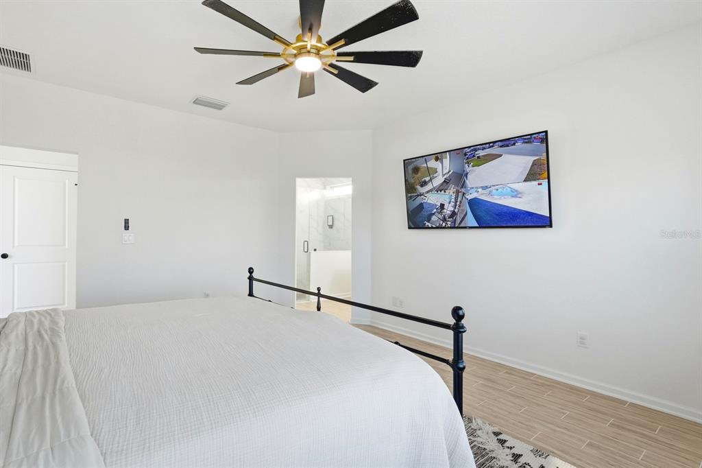 140 Nighthawk Lane Palm Coast, FL 32164 - Photo 17 of 43 a bedroom with a bed and a painting on the wall