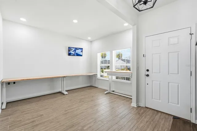 a view of a hallway with wooden floor and staircase