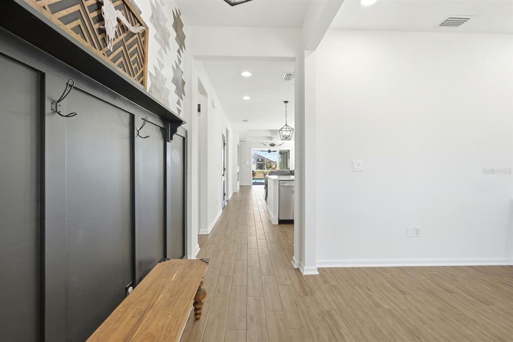 140 Nighthawk Lane Palm Coast, FL 32164 - Photo 31 of 43 a view of a hallway with wooden floor and a bathroom