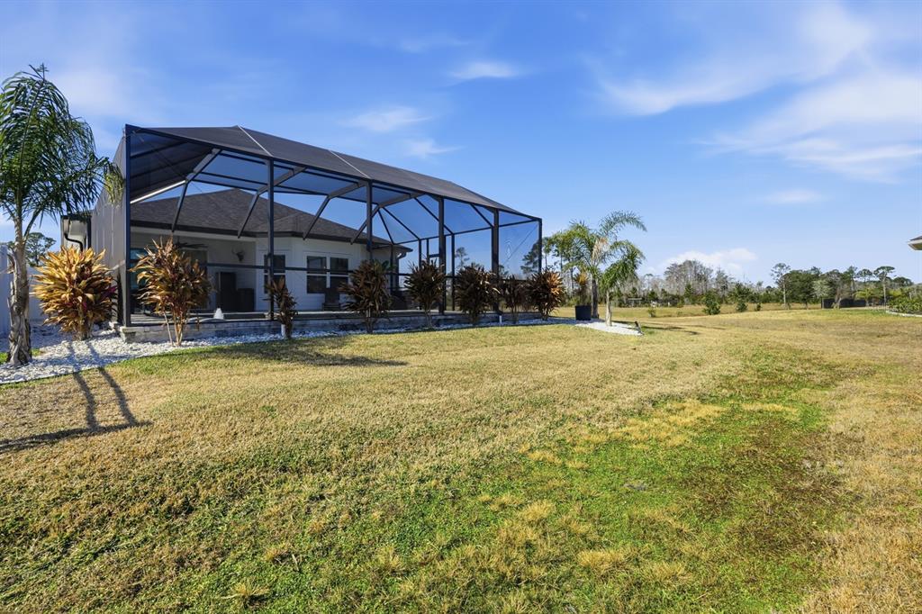 140 Nighthawk Lane Palm Coast, FL 32164 - Photo 36 of 43 a view of a house with a yard