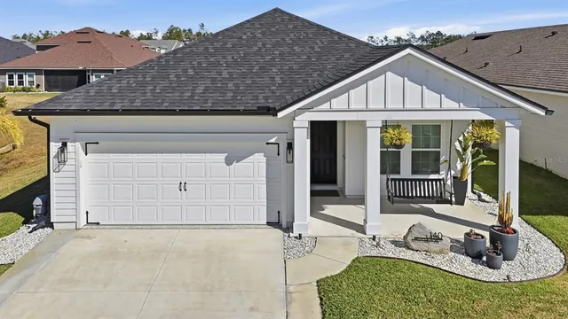 an aerial view of a house with garden space and ocean view