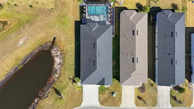 an aerial view of a house with a swimming pool yard and outdoor seating