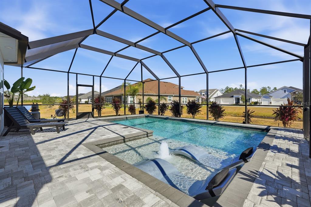 140 Nighthawk Lane Palm Coast, FL 32164 - Photo 7 of 43 a view of a swimming pool with a patio