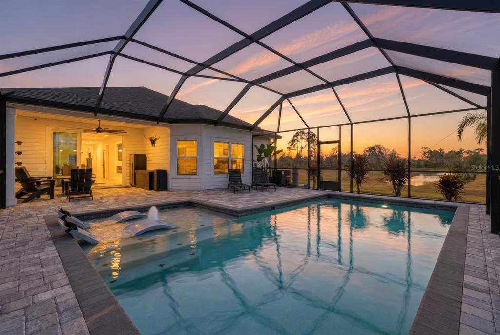 140 Nighthawk Lane Palm Coast, FL 32164 - Photo 10 of 43 a view of a swimming pool with a porch
