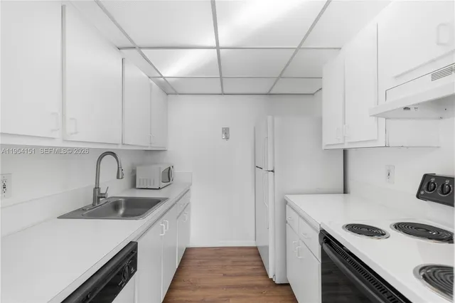 a kitchen with stainless steel appliances a sink stove and refrigerator
