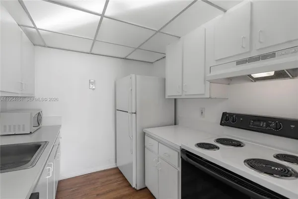 a kitchen with stainless steel appliances a stove a sink and cabinets