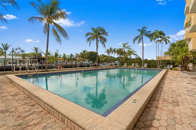 a view of swimming pool with a table and chairs